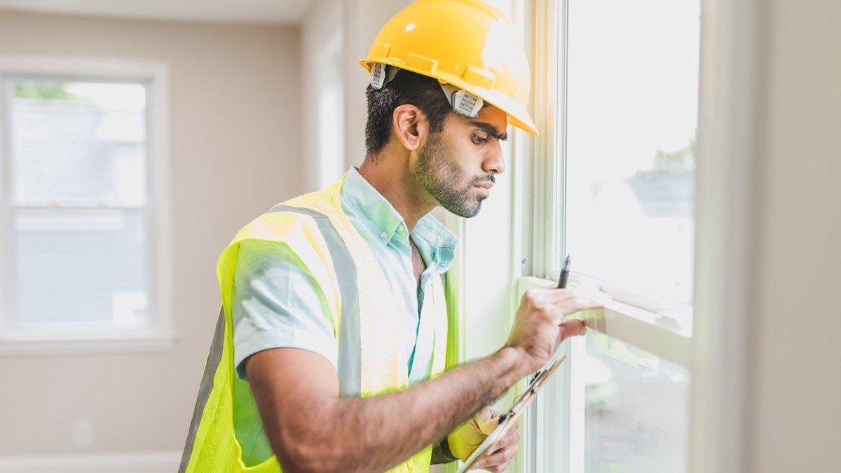 Professional roofing contractor inspecting a residential window installation