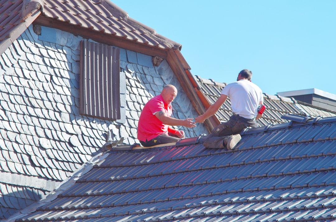 Professional roofing inspectors working on a residential roof
