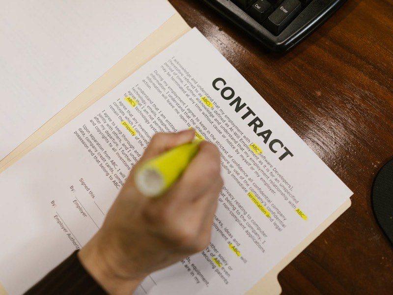 Professional reviewing contract documents at a desk